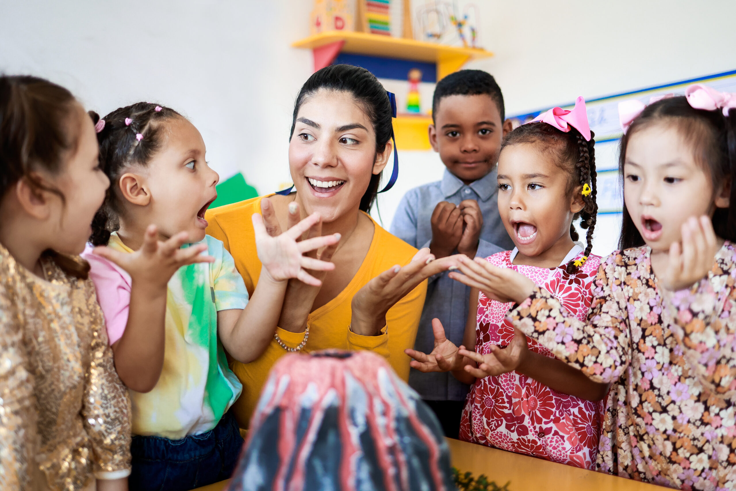 Teacher helping children learn during a classroom science activity